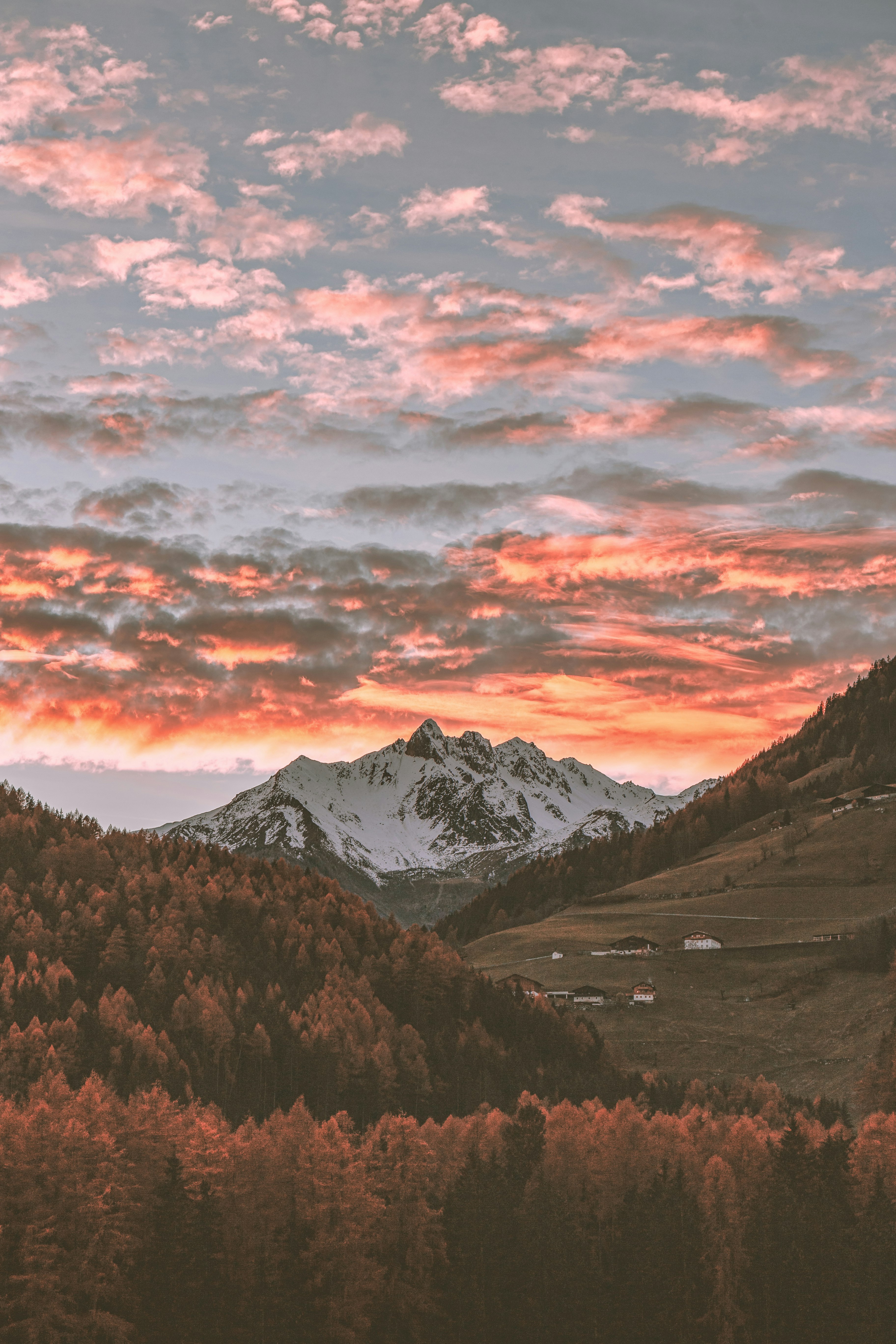 snow covered mountain during sunset